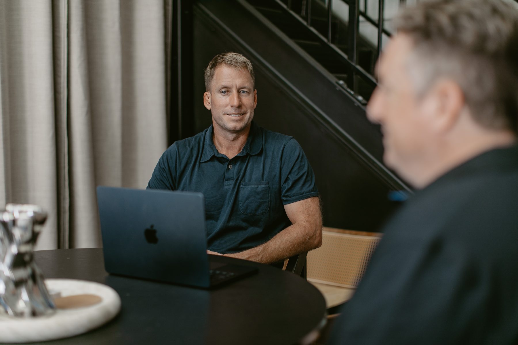 Two Rapsey Griffiths practitioners in discussion at a meeting table